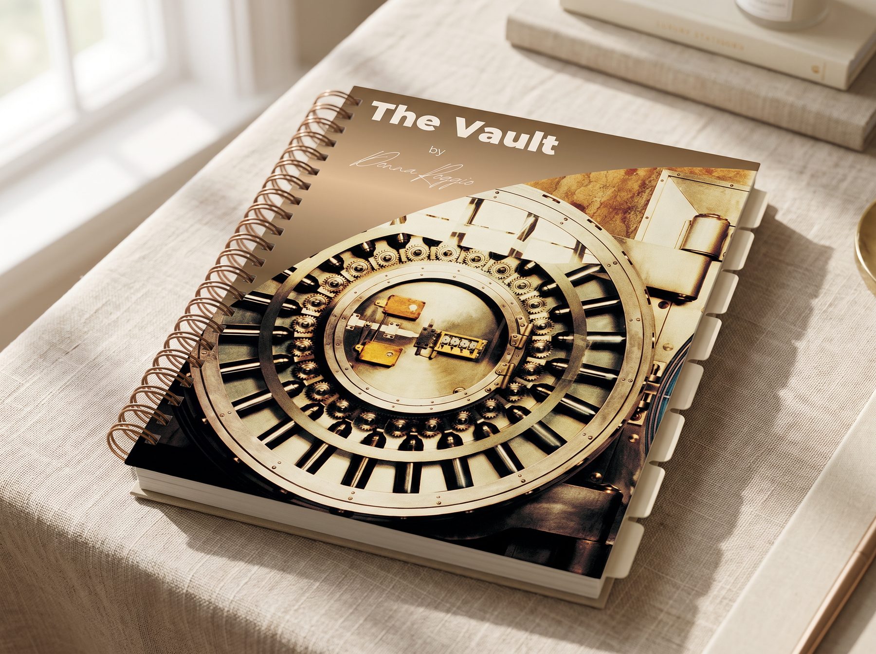 The Vault printed planning book, linen cover, front three-quarter view, spiral bound with seven tabs